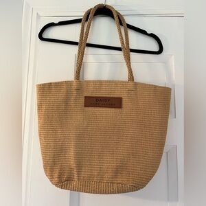 Marc Jacobs Daisy straw tote bag is a woven raffia-style shopper shoulder bag